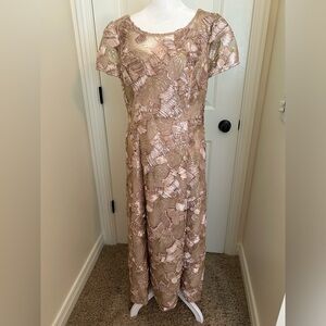 Gold short sleeve gown. Swirl ribbon and sequins details. Stretchy comfort.